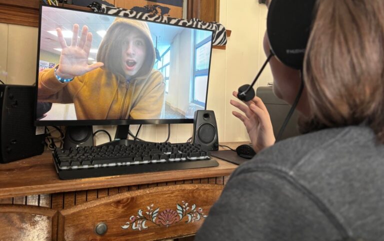 Cameron talking to Antonio as if they both were on a video call, with Cameron giving Antonio some website support.